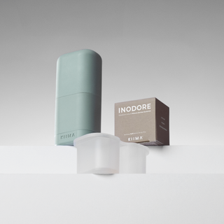 KIIMA Inodore unscented refillable deodorant kit featuring a mint green applicator and eco-friendly refill pods.