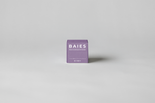 KIIMA Baies natural lip balm packaging on a gray background.
