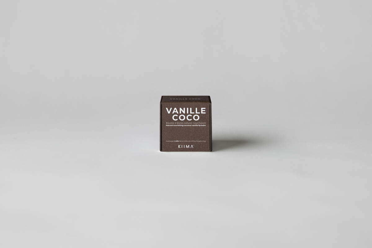KIIMA Vanille Coco natural lip balm packaging on a gray background.