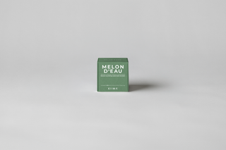 KIIMA Melon d'eau natural lip balm packaging on a gray background.