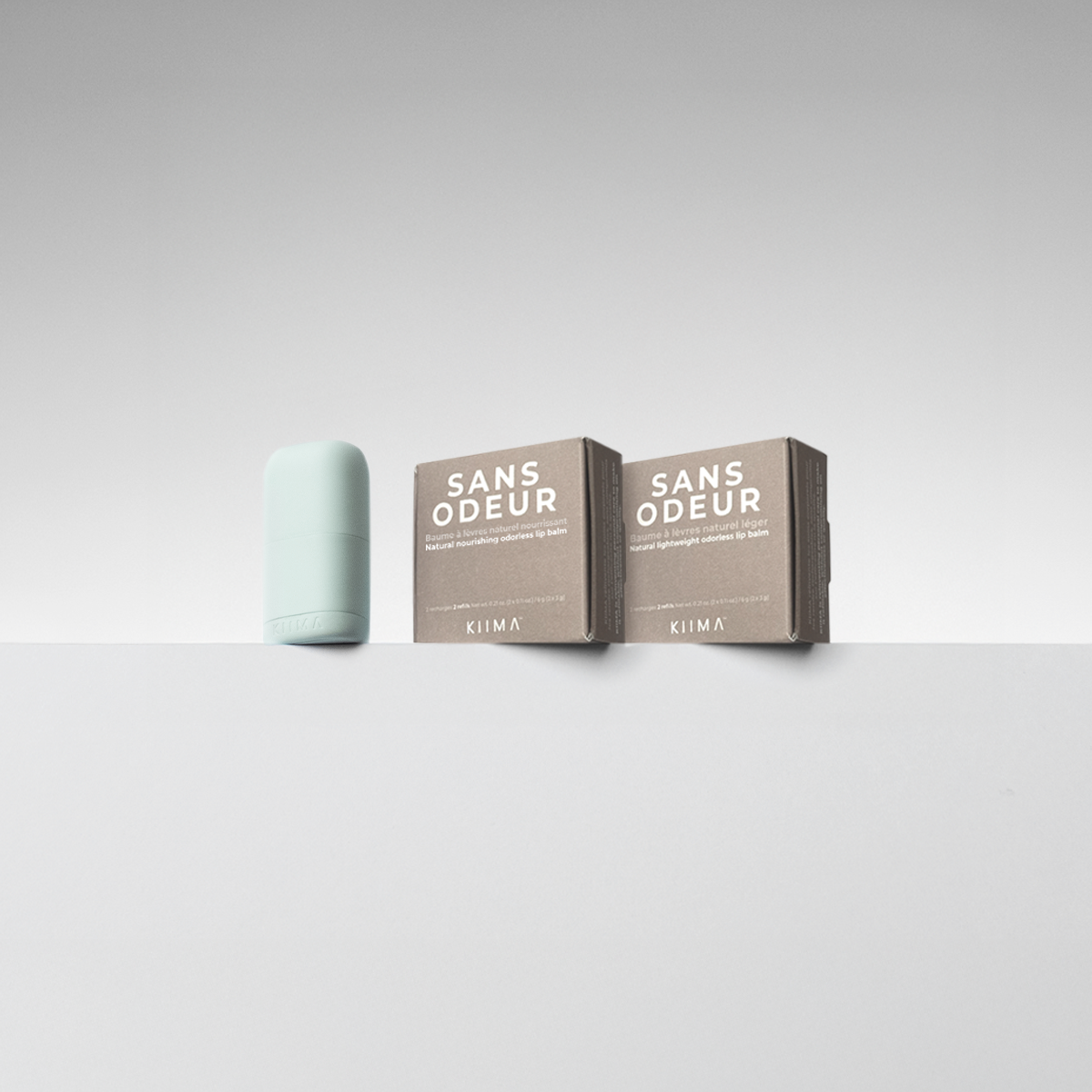 SANS ODEUR refills with blue refillable lip balm packaging on a light gray background