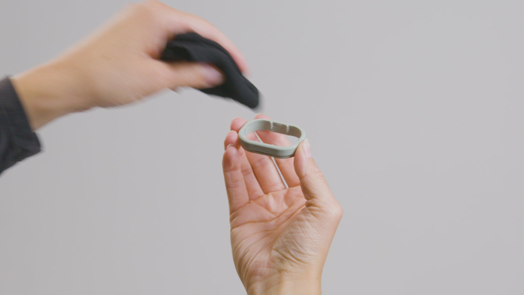 Wiping the interior of a KIIMA refillable deodorant applicator with a damp cloth to maintain hygiene and longevity between refills.