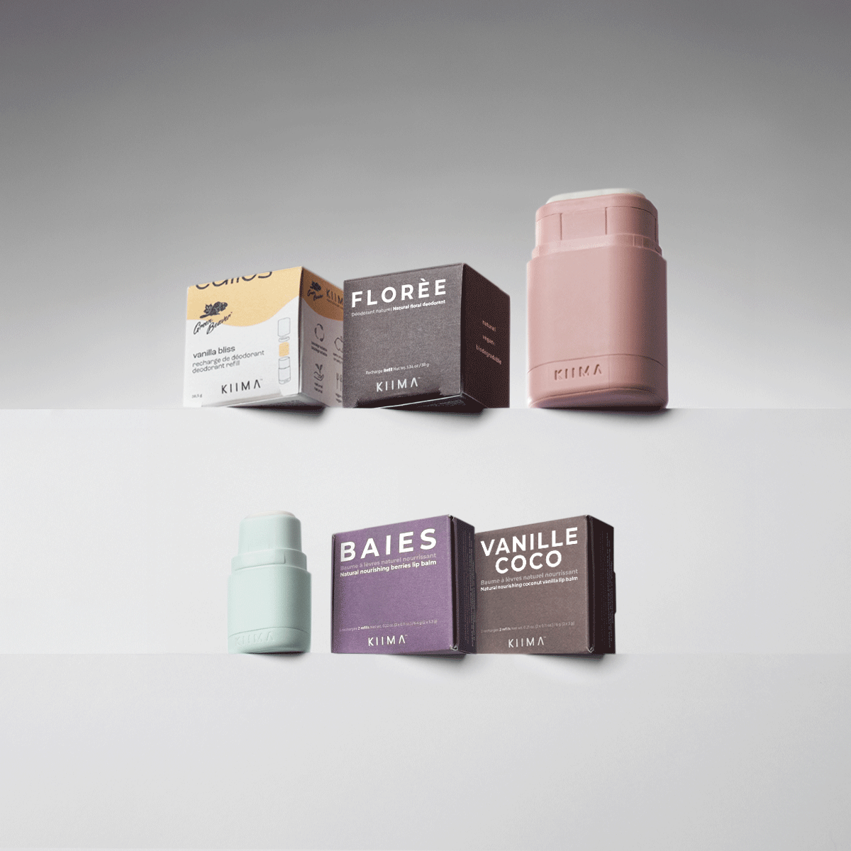 KIIMA refillable skincare set featuring a pink natural deodorant applicator and mint green lip balm case with compostable refills.