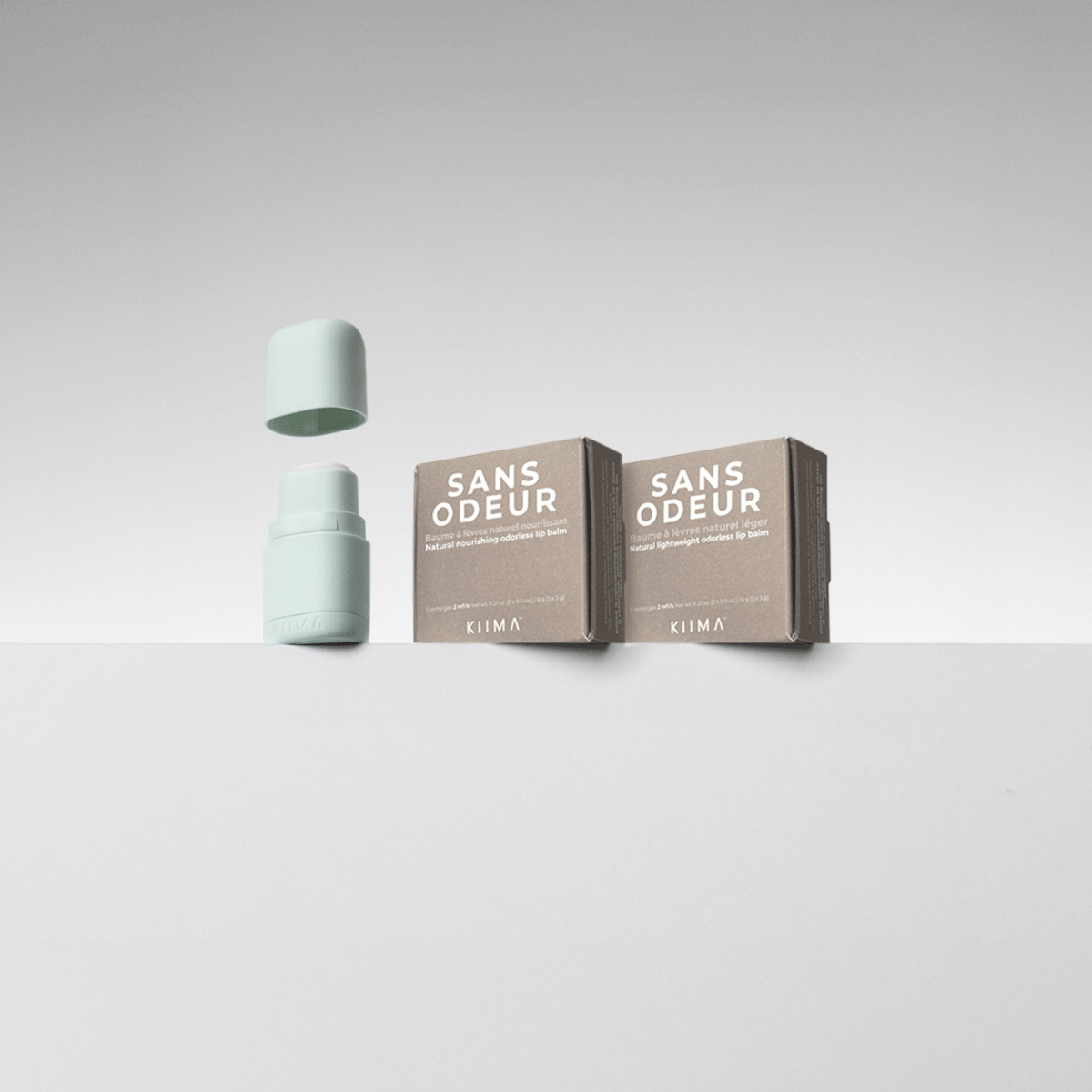 KIIMA Sans Odeur refillable lip balm GIF showing a mint green reusable applicator and unscented, natural nourishment refills.