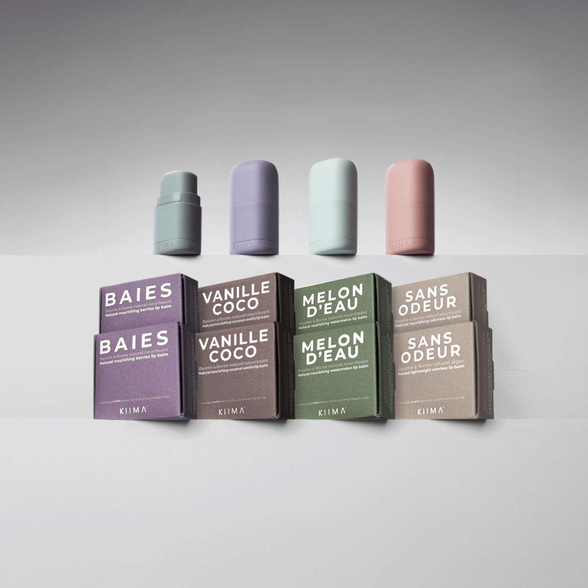 GIF of KIIMA refillable lip balm applicators opening to show natural refills with compostable boxes in Baies, Vanille Coco, and Melon d’Eau.